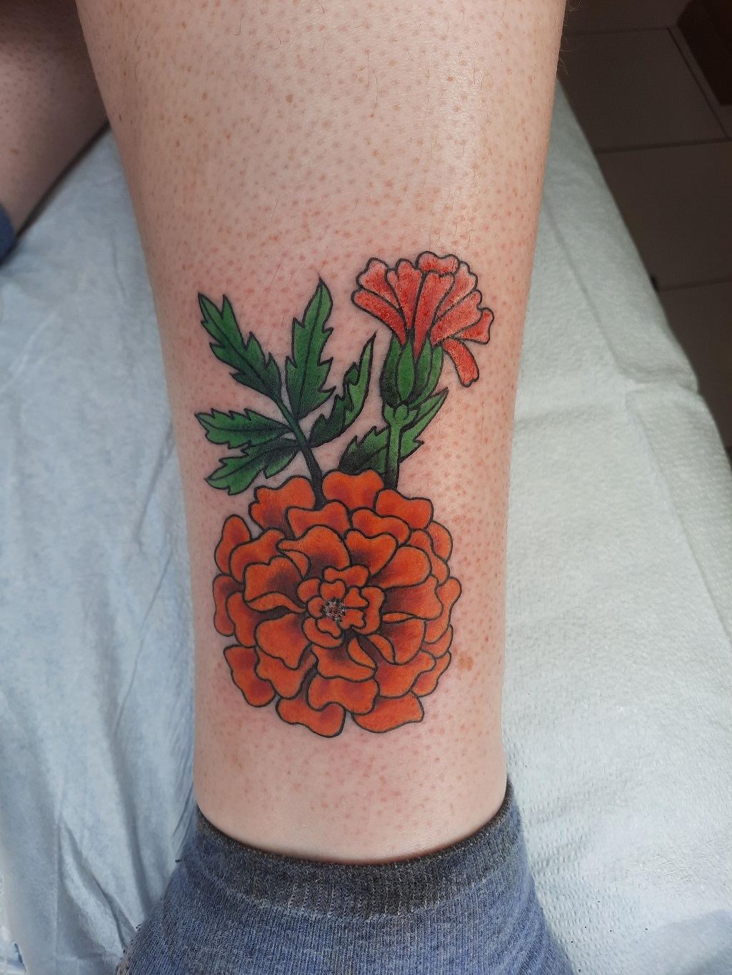 small marigold flower tattooTikTok Search